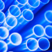 Plastic tubing in a foreground with a blue light