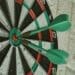 Photography of two darts in the center of a target