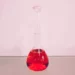 picture of a red liquid in a volumetric flask.